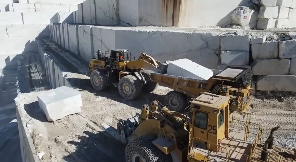 Transporting the marble block with wheel loader and dumper