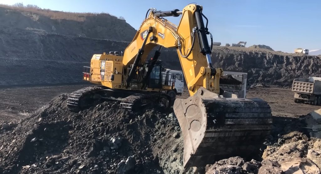 Excavator digging coal at coal mine