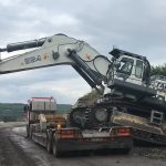 Loading excavator on truck