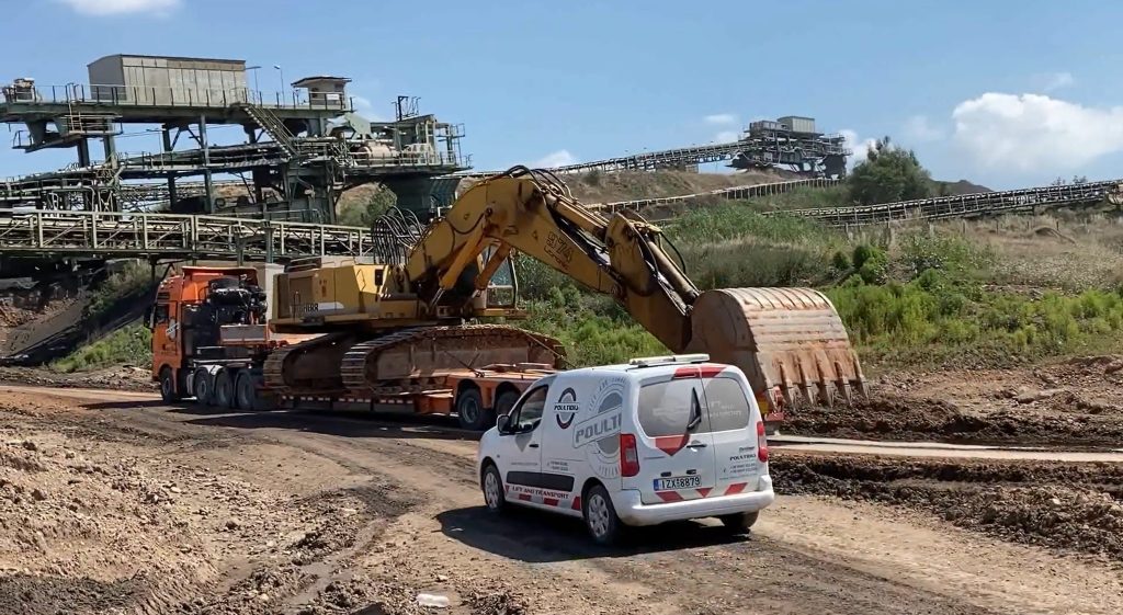 Transporting excavator on heavy duty trailer