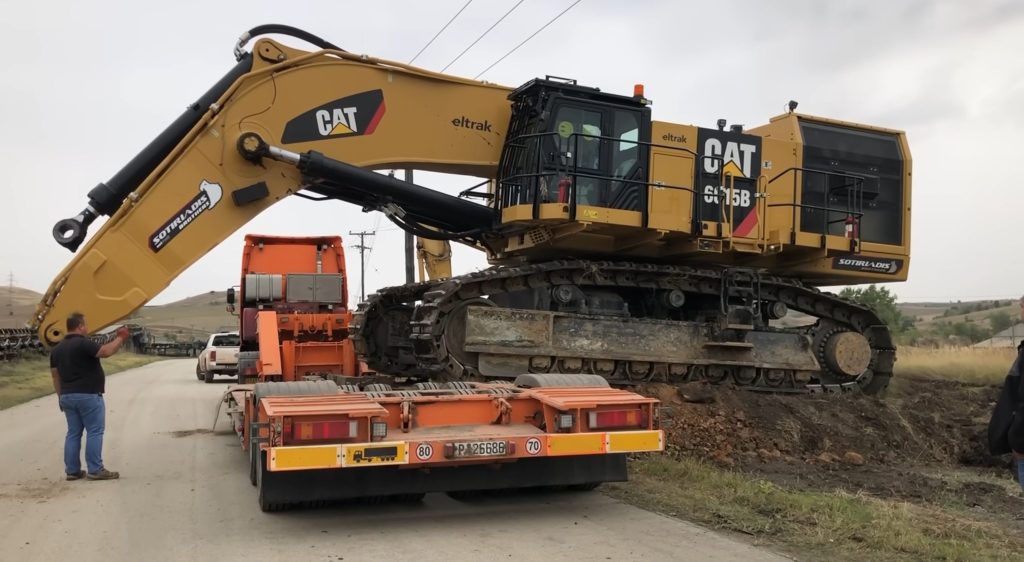 Loading excavator on heavy duty trailer