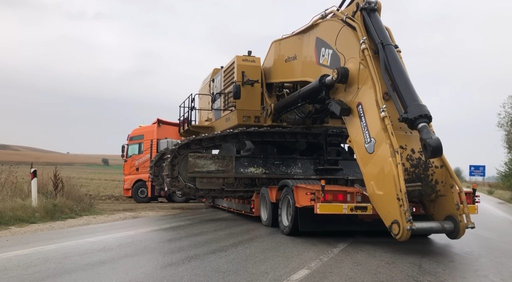 Moving excavator on heavy duty truck