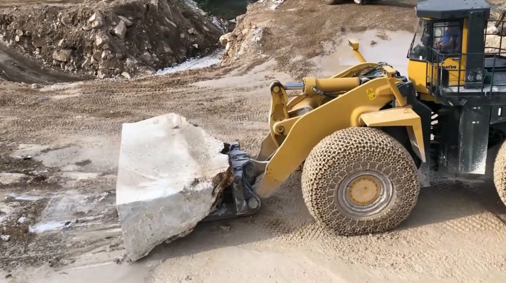 Wheel loader moving marble piece