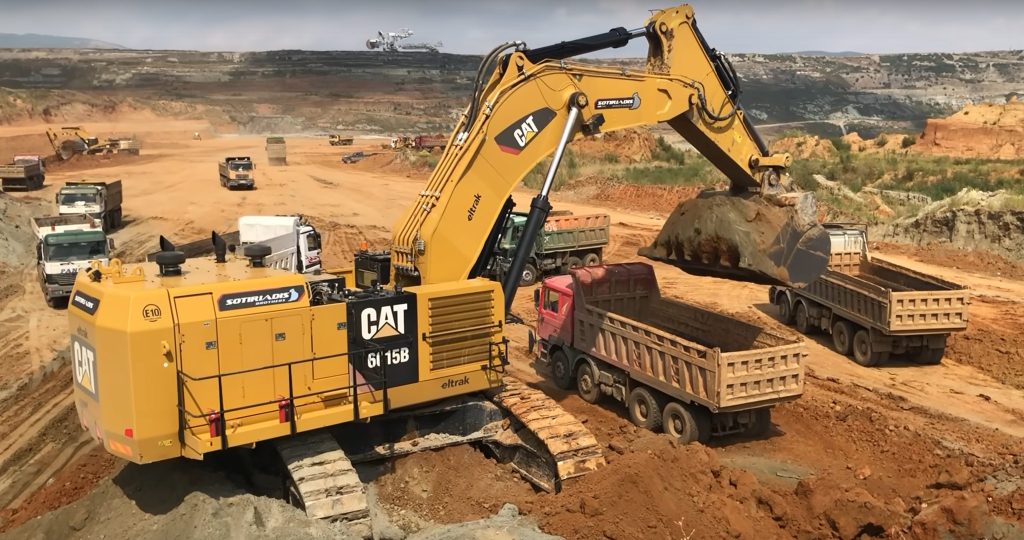 Caterpillar 6015B excavator in busy mining site