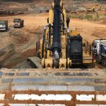 Caterpillar 6015B excavator in busy mining site