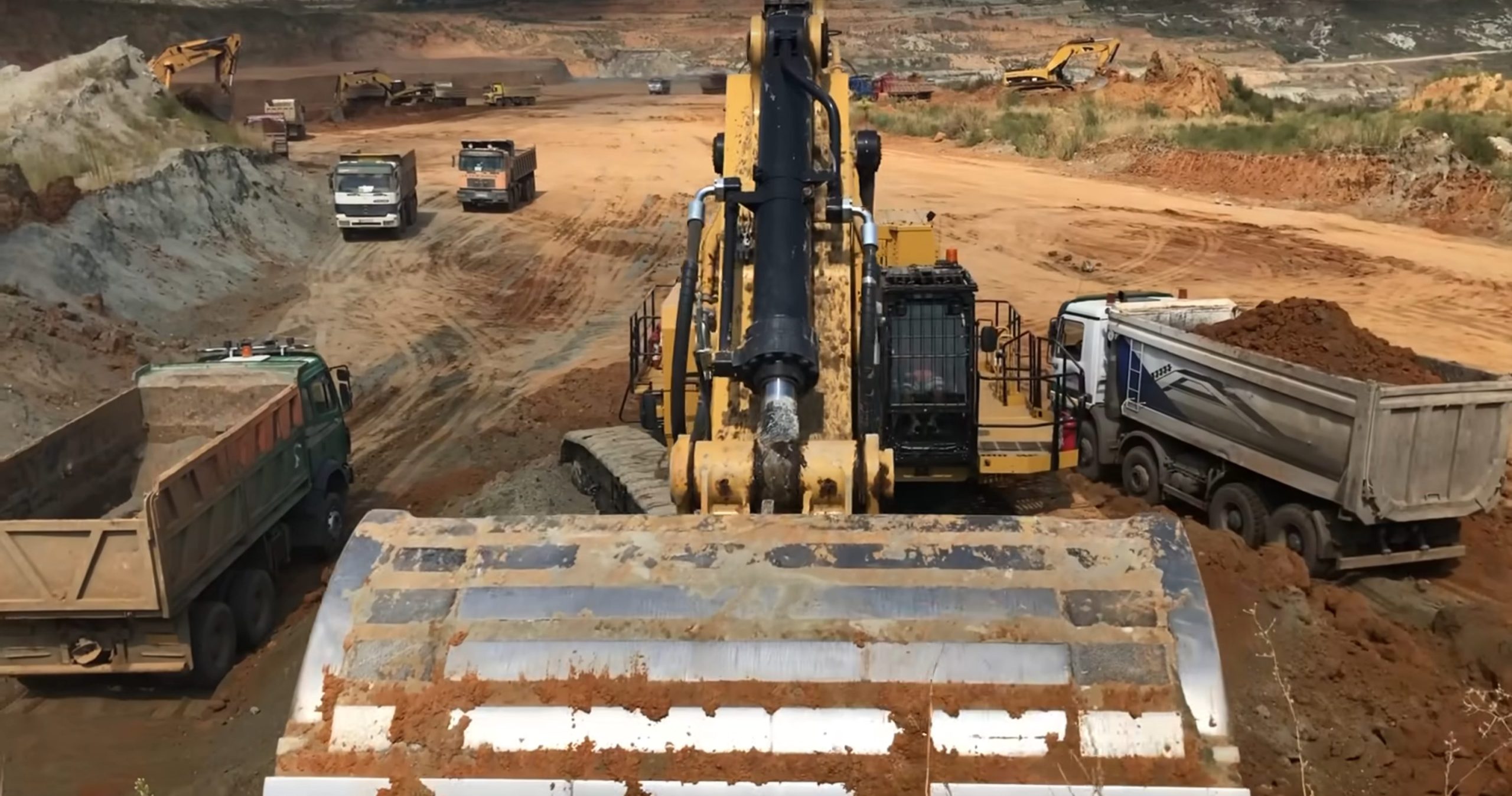 Caterpillar 6015B excavator in busy mining site