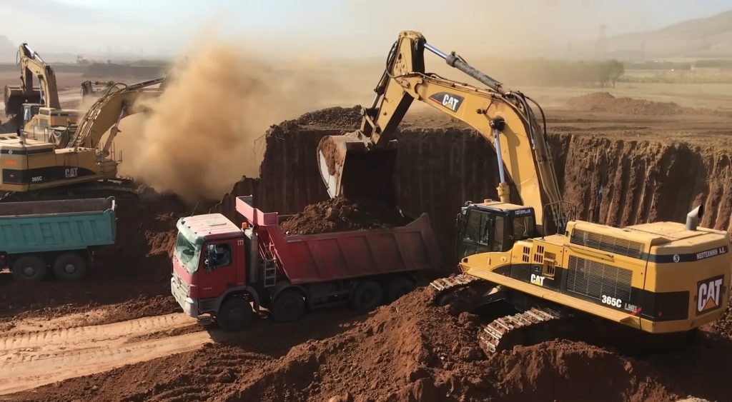 Caterpillar 365C Excavator Loading Trucks