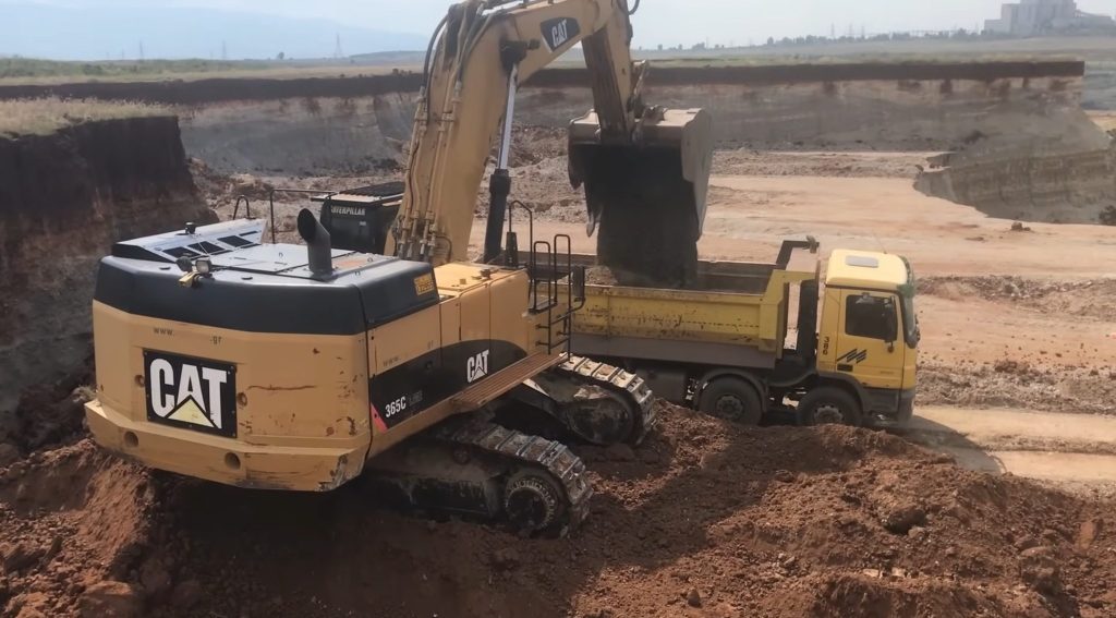 Caterpillar 365C Excavator Loading Trucks