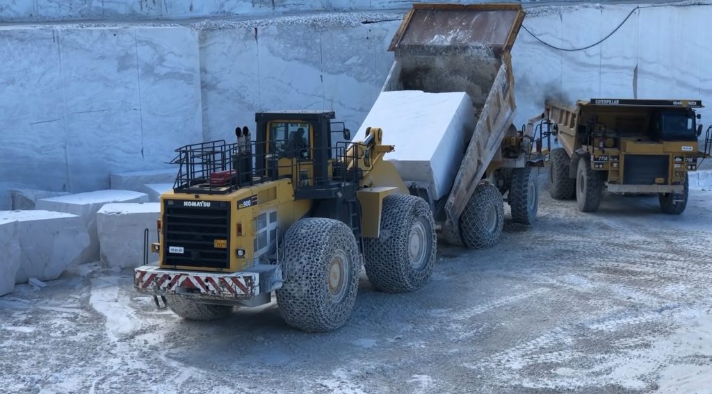 Wheel loader loading marble block on dumper