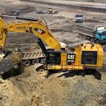 Caterpillar 6015B excavator loading truck