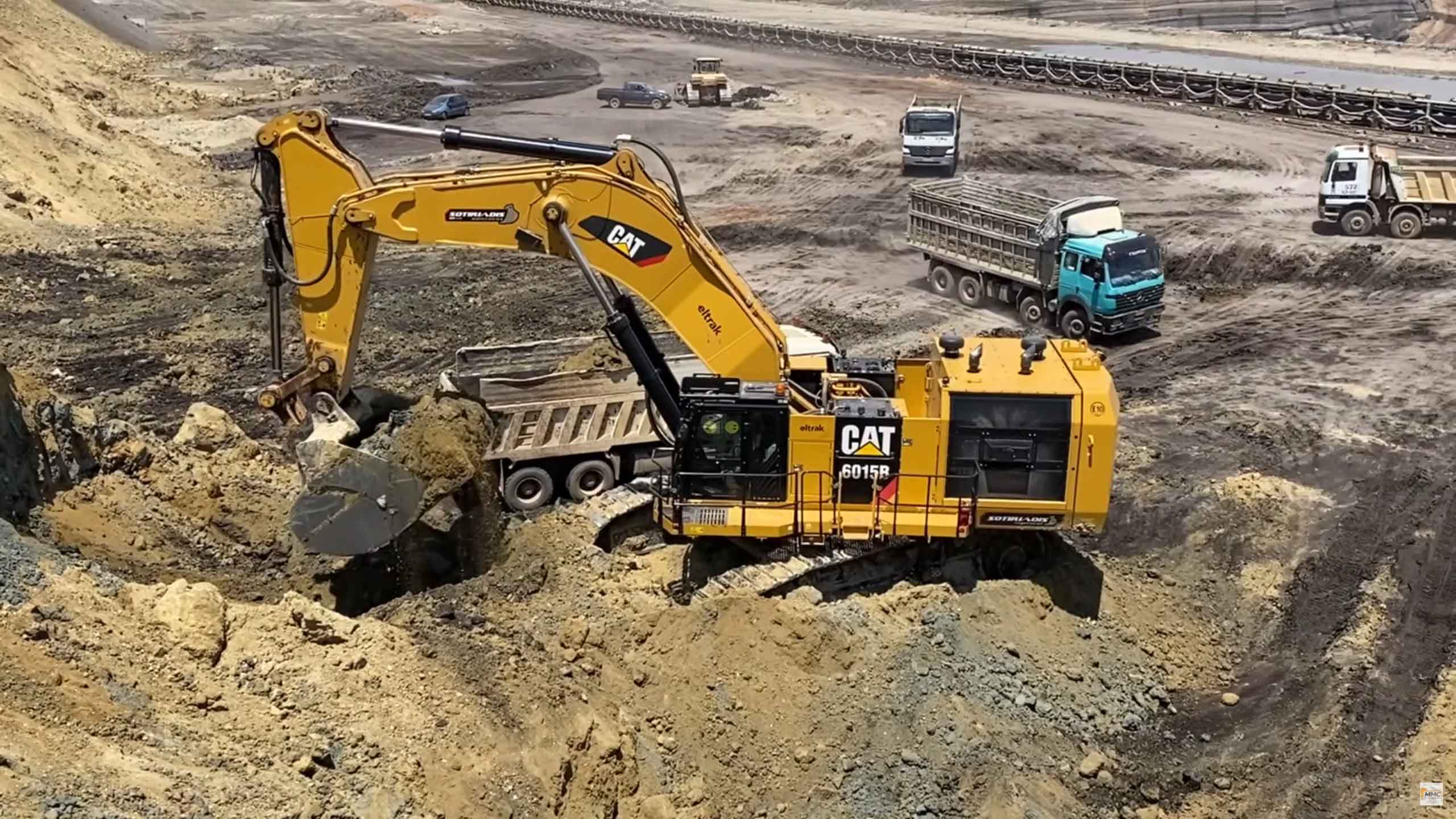 Caterpillar 6015B excavator loading truck