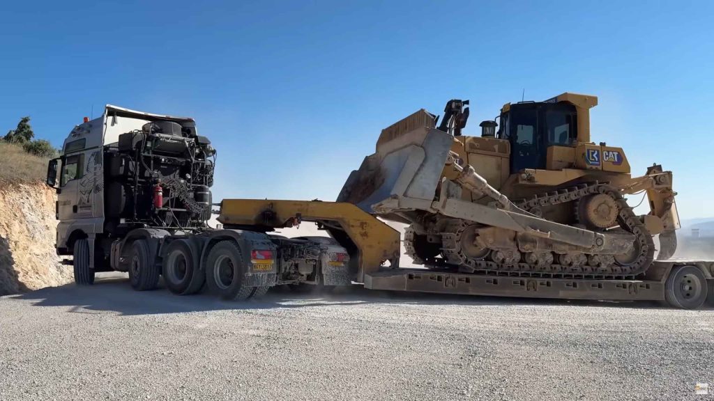 Heavy duty truck transporting bulldozer