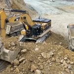 Caterpillar 390D Excavator Loading Trucks