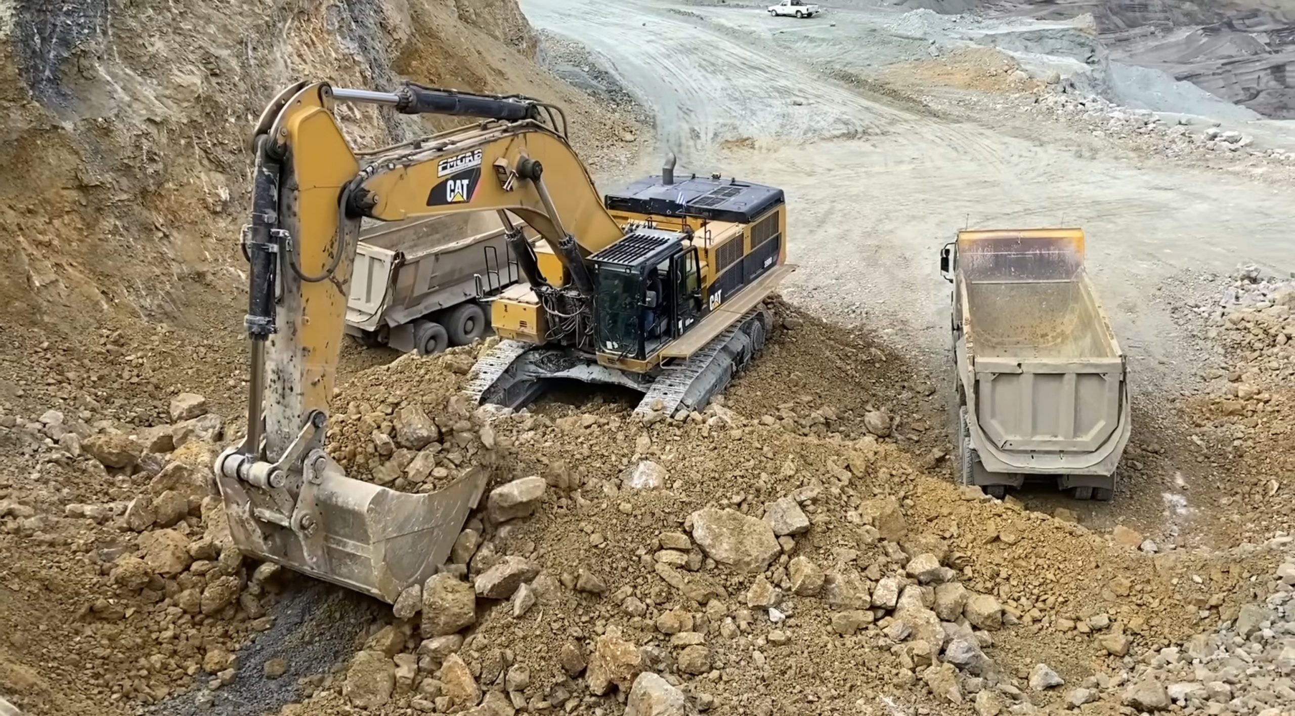 Caterpillar 390D Excavator Loading Trucks