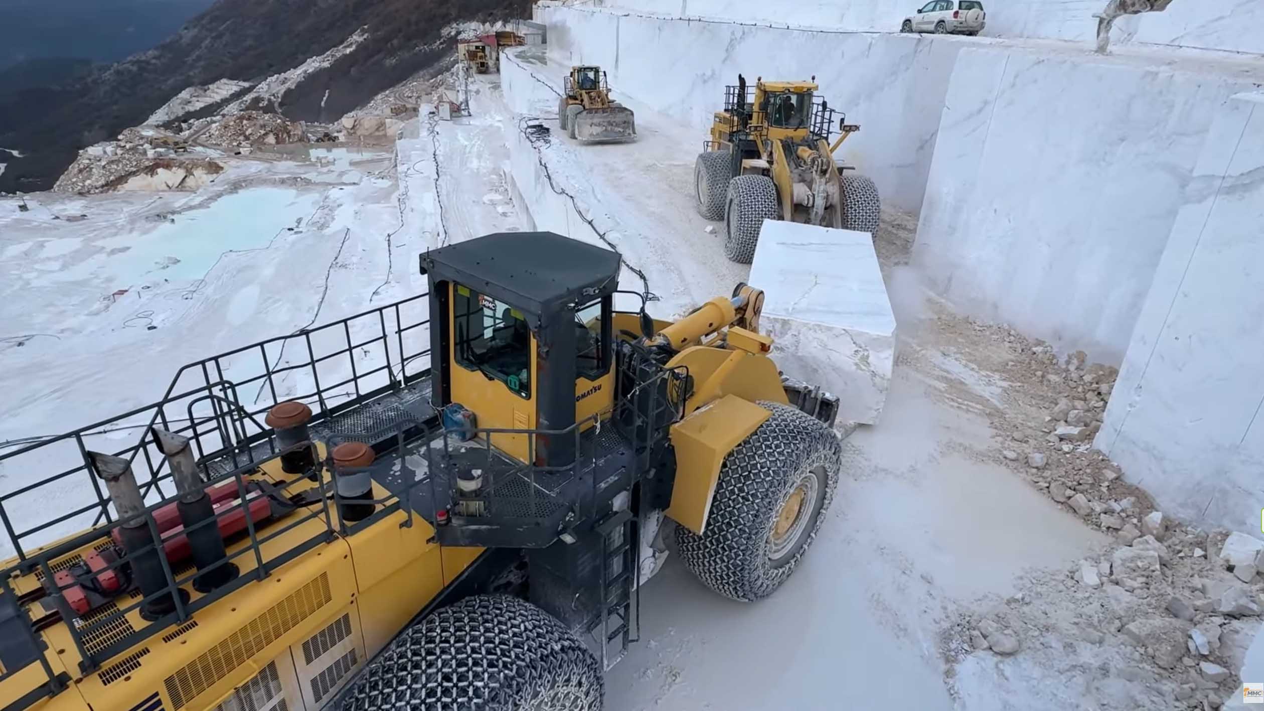 Komatsu wheel loaders transfering exrtacted marble block at marble quarry