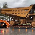 Transporting Caterpillar 777C dumper in wet road