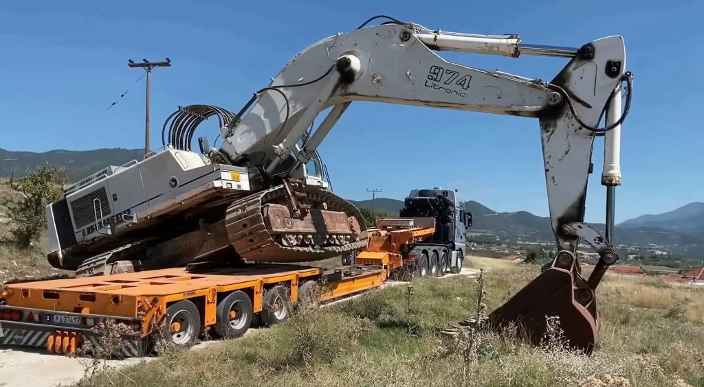 Unloading excavator from truck