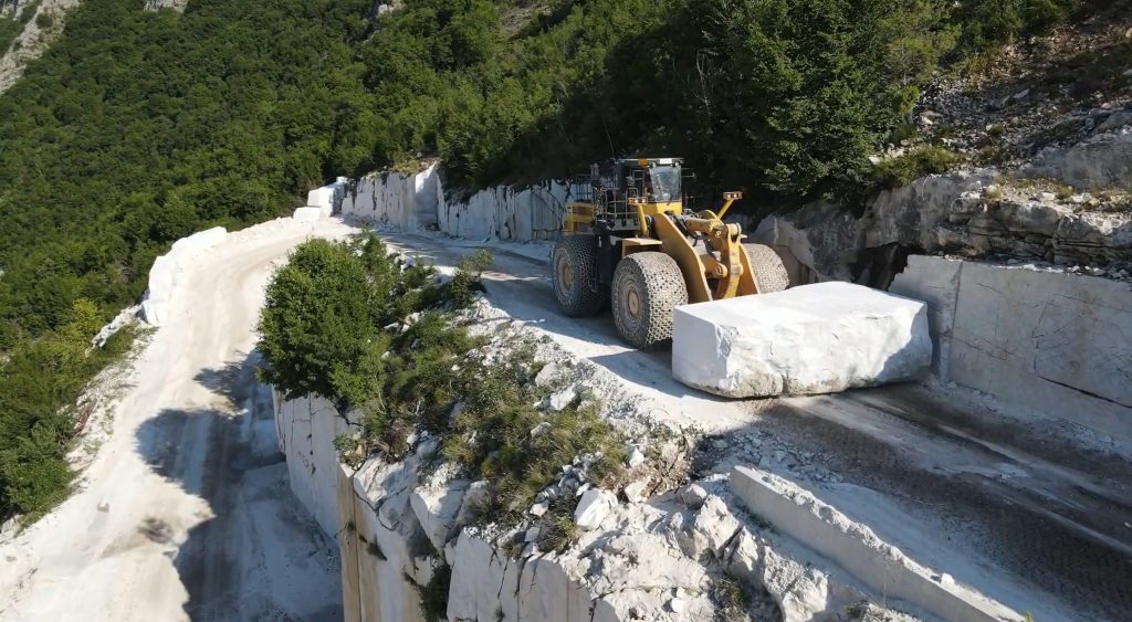 Wheel loader transporting marble block by driving backwards