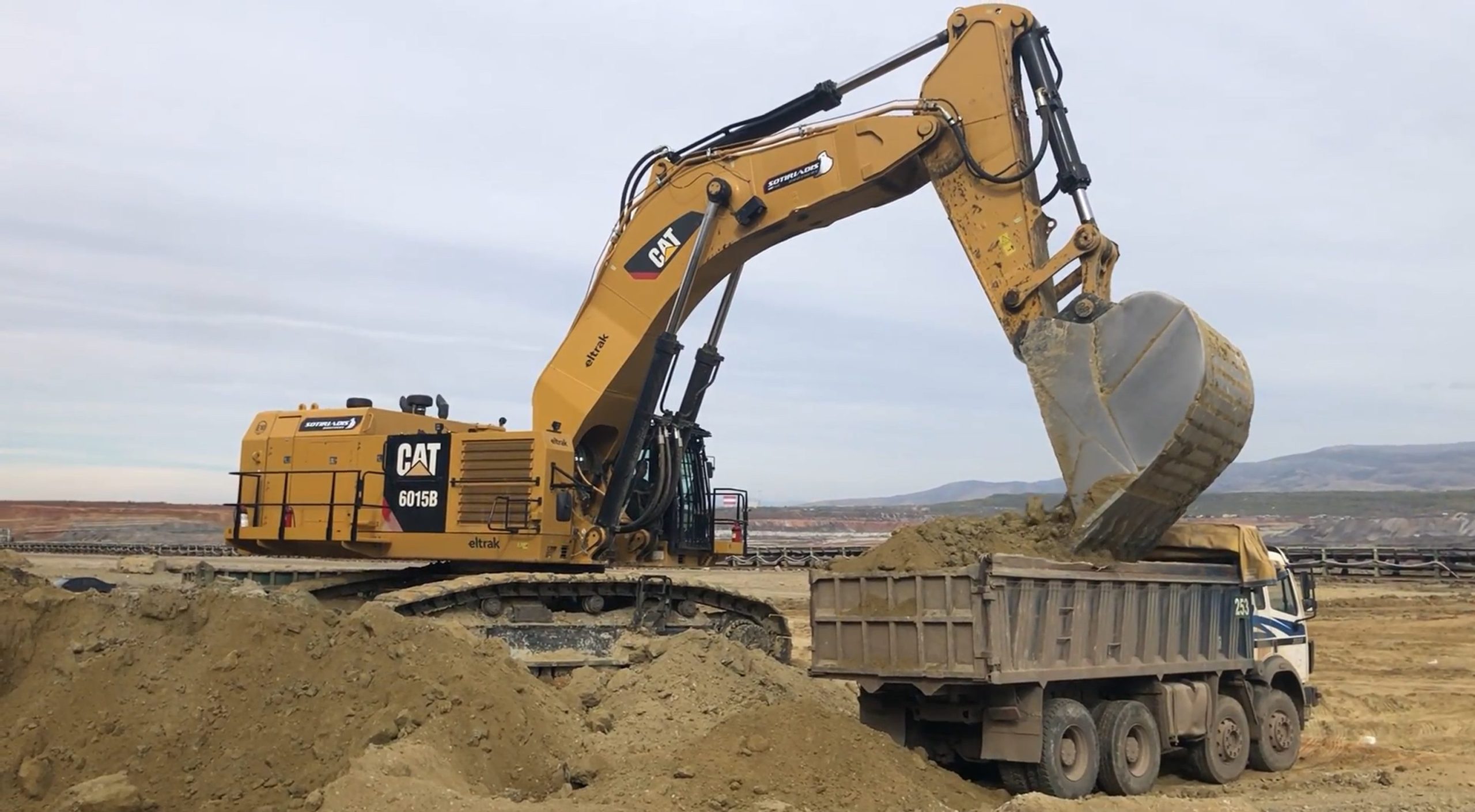 Caterpillar 6015B Excavator Loading Trucks